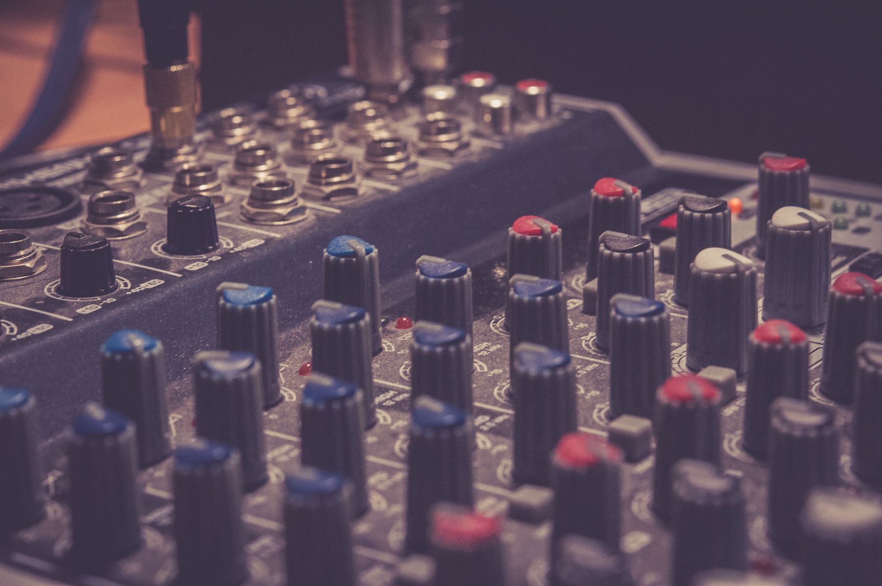 Close-up of the controls on a music studio mixing console.